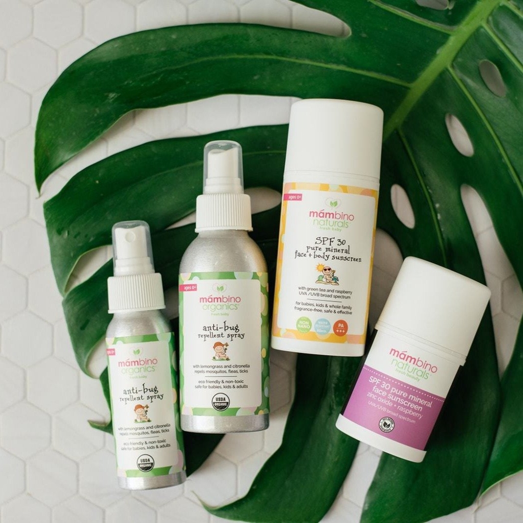 A group of personal care products sitting on top of a leaf.