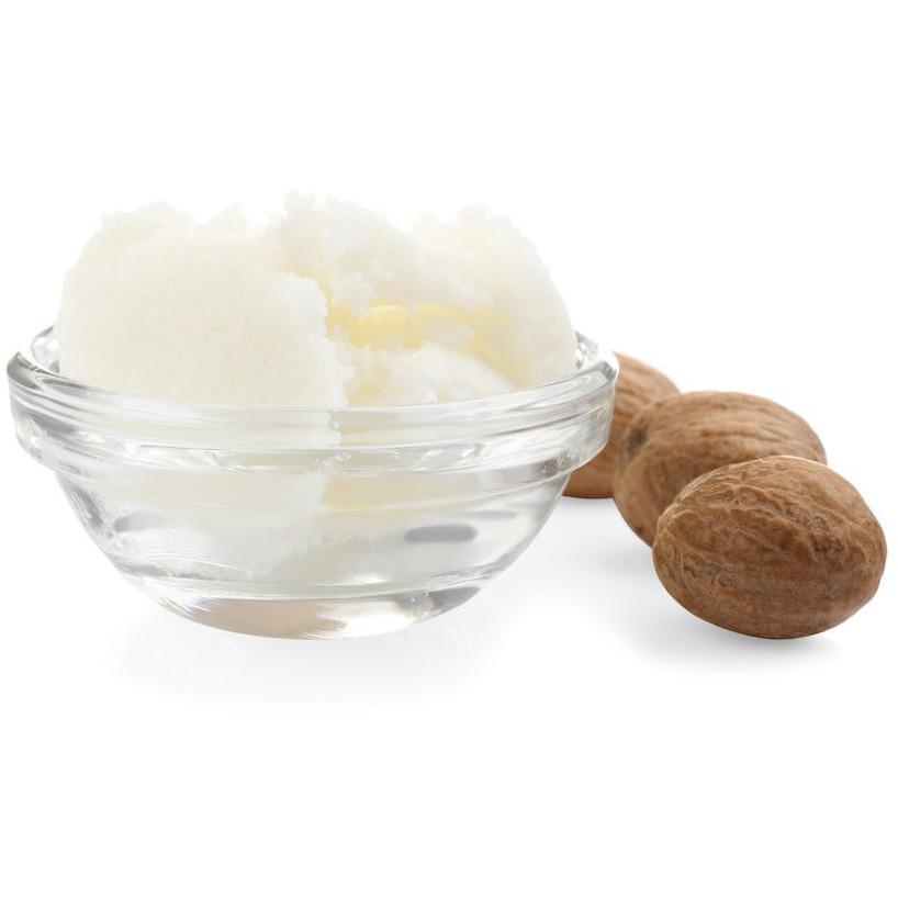 Shea butter in bowl and nuts isolated on white