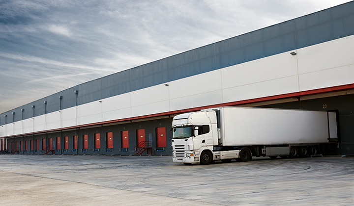 A white truck parked in front of a building.